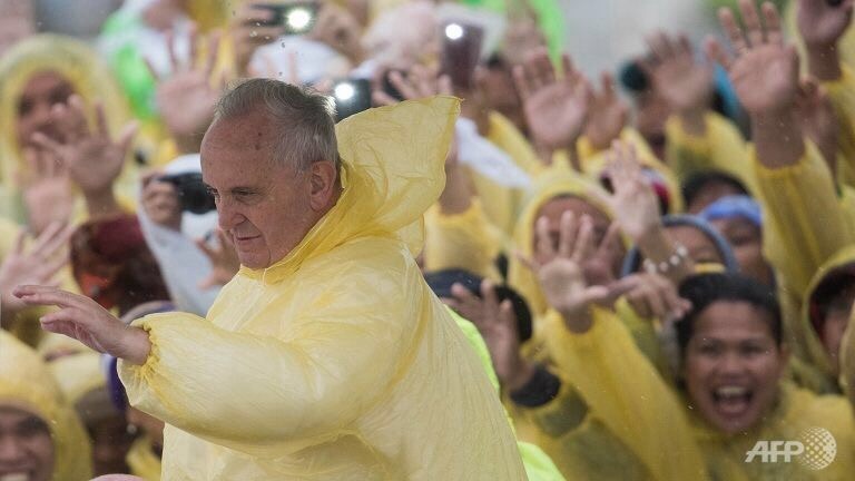 Francis braves the wind and rain at open air Mass in Tacloban, Leyte, Philippine.